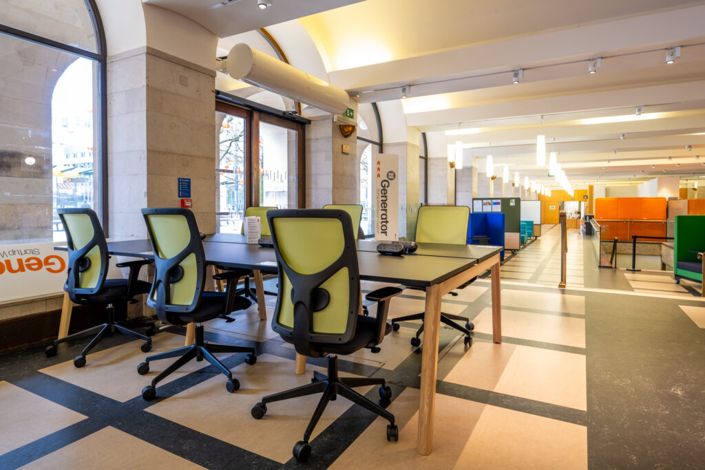 A picture of desks and chairs in a coworking space